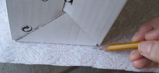 6. Carefully unwrap the magazine file, marking where the corners of the magazine file spine hit the fabric.